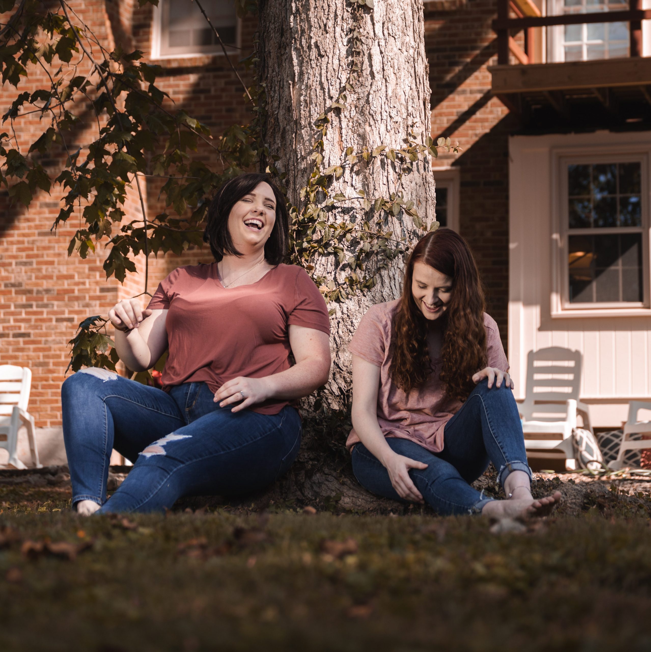 About Us 1 Two women, catherine ballard, and christina wherthey, sitting under a tree on the about crossmore marketing page.